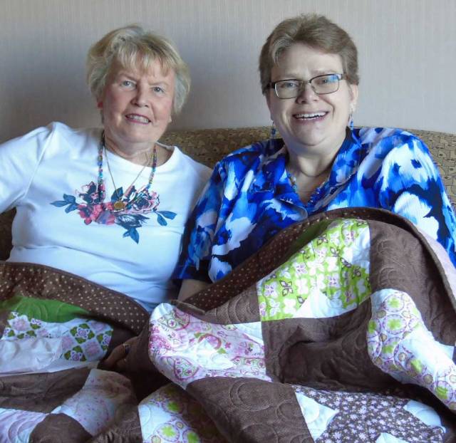 The Kid and her dear friend, Barb, met again  after many years.  They're sitting under a quilt Barb made for Krista as a gift.